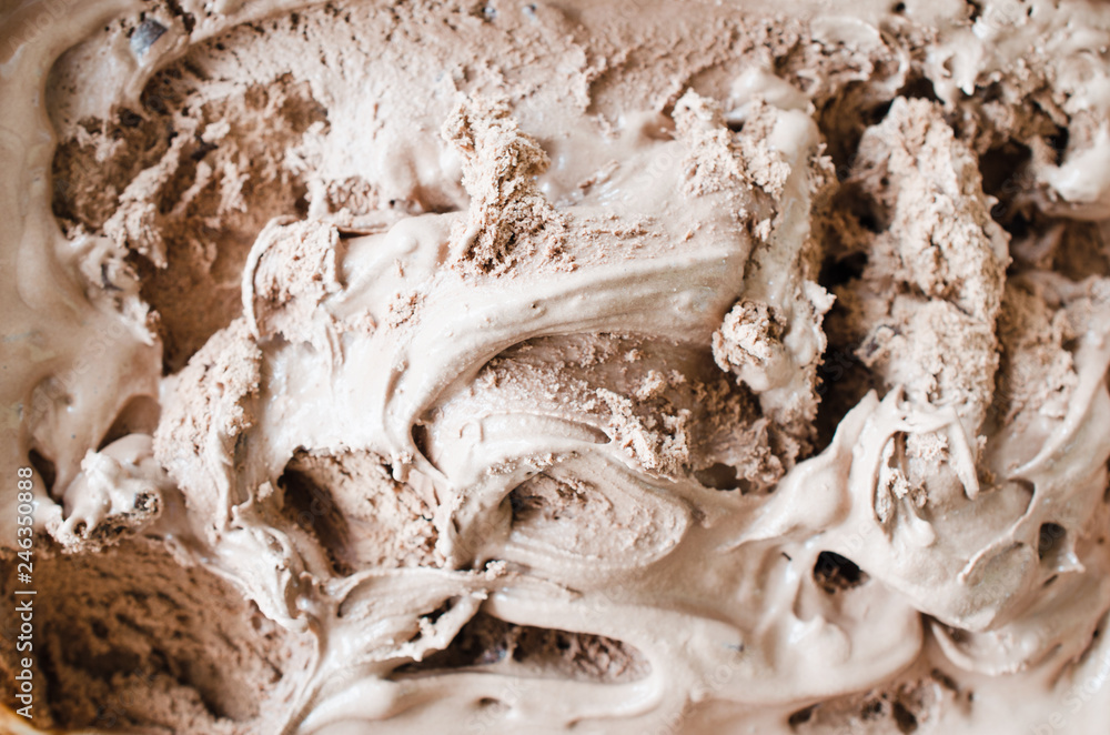 Texture of melting chocolate ice cream. Brown background.