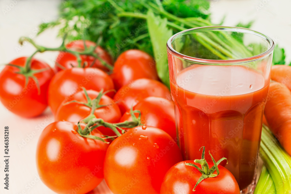 Glass of different vegetable juices with carrots, tomatoes and c Glass of different vegetable juices with carrots, tomatoes and c