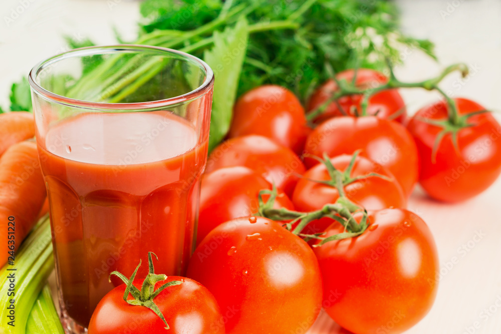 Glass of different vegetable juices with carrots, tomatoes and c Glass of different vegetable juices with carrots, tomatoes and c