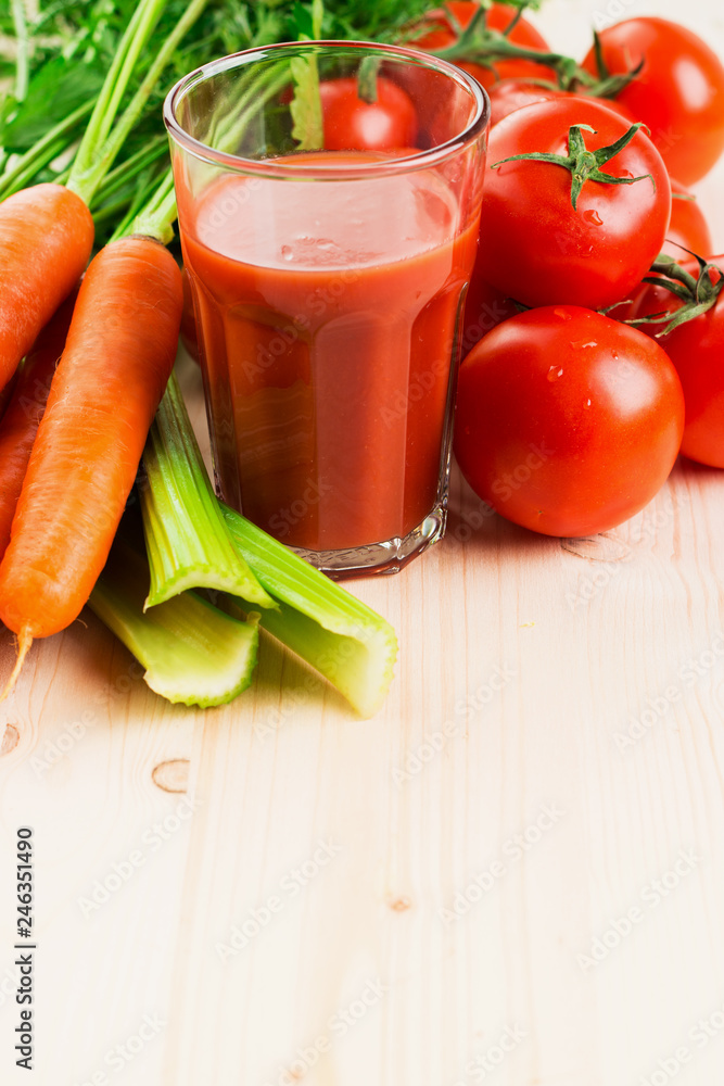 Glass of different vegetable juices with carrots, tomatoes and c