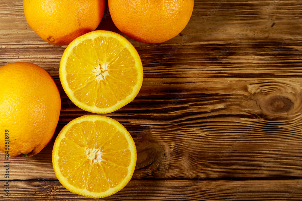 Fresh oranges on wooden table Fresh oranges on wooden table