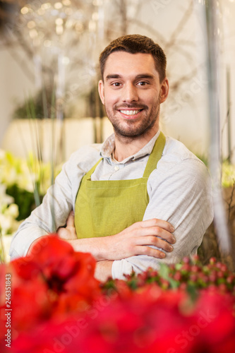 sale, small business and floristry concept - happy smiling florist man or seller at flower shop © Syda Productions