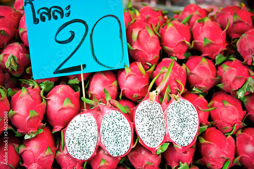 Many fresh, ripe red dragon fruits piled up at the Klong Toey Market in Bangkok, Thailand photo