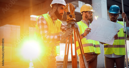 Slika na platnu Team of construction engineers working on building site