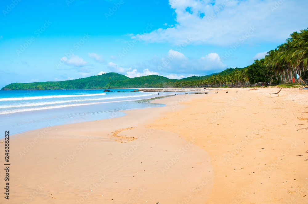 Light waves. Ocean and sand. Summer Islands, blue sky and clouds. Light waves. Ocean and sand. Summer Islands, blue sky and clouds.