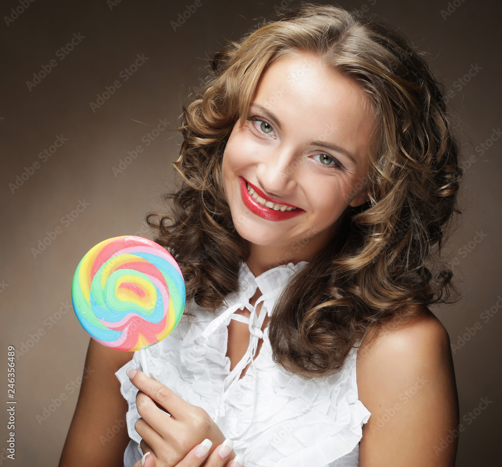 Young pretty woman with colorful lollipop 