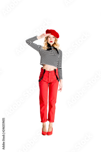 attractive blonde woman in red beret holding hand on head isolated on white