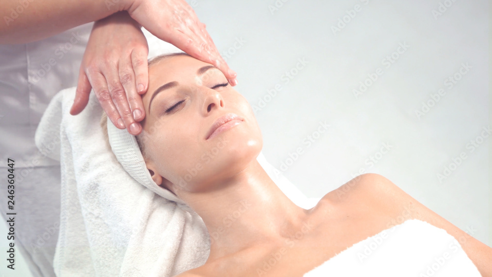 Young attractive woman getting spa treatment over white background. Young attractive woman getting spa treatment over white background.