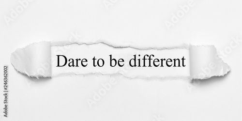 Fotografie Dare to be different on white torn paper