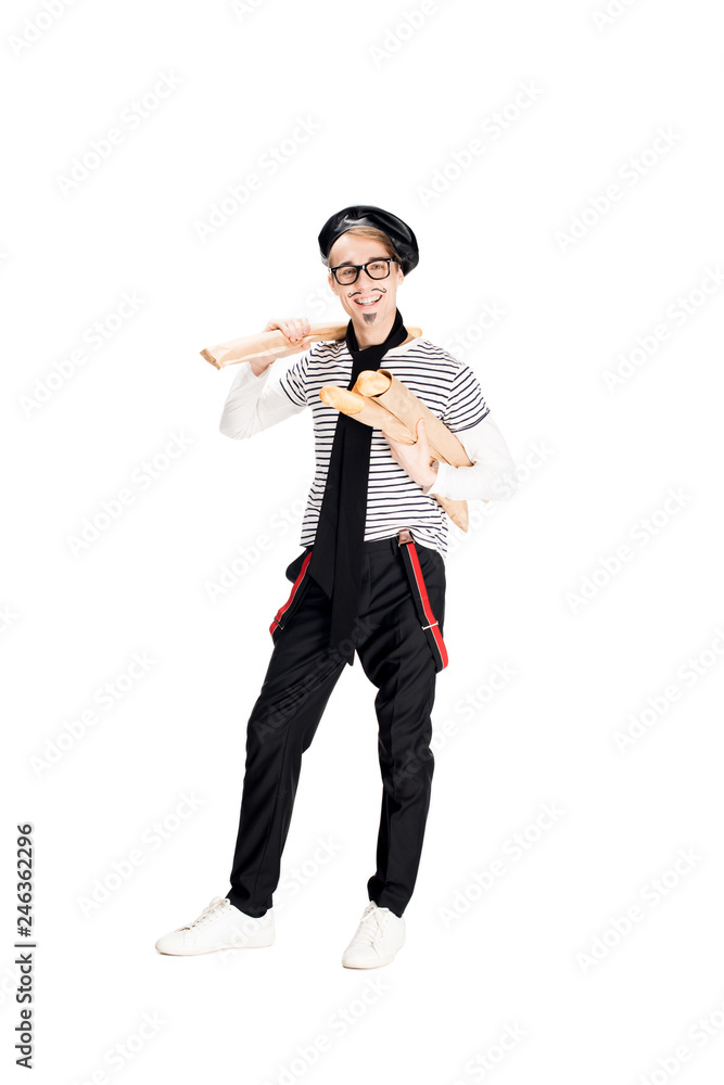 Naklejka premium handsome french man smiling while holding baguettes isolated on white