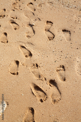 Many footprints on sand on the beach