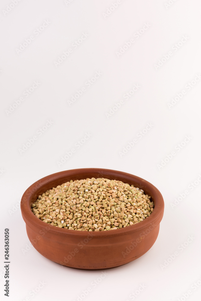Natural fresh green buckwheat in bowl isolated on white background. Natural fresh green buckwheat in bowl isolated on white background.