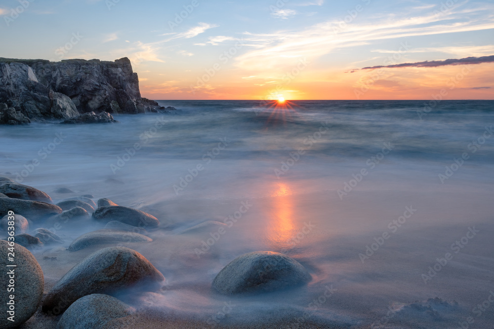 French landscape - Bretagne. A beautiful beach with wild cliffs in the background at sunset.