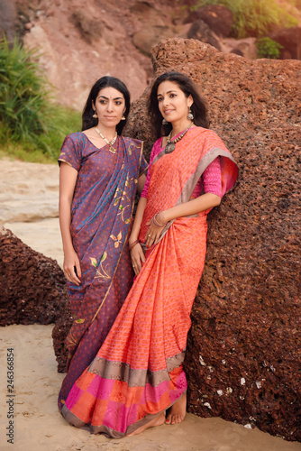 Two beautiful indian woman in beautiful traditional saree at sunset