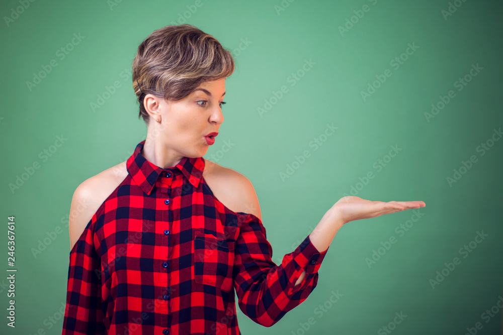 People and emotions -a portrait wondering woman holding something on her hand People and emotions -a portrait wondering woman holding something on her hand