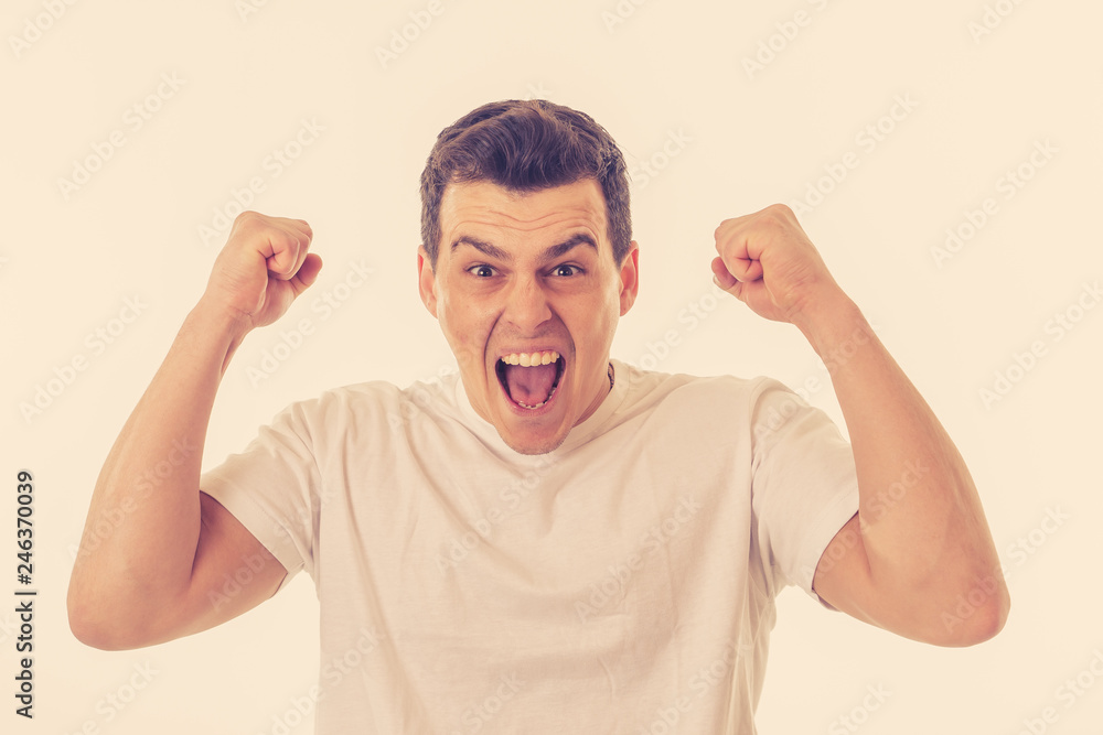 Close up portrait of happy successful man celebrating winning and victory looking amazed Close up portrait of happy successful man celebrating winning and victory looking amazed