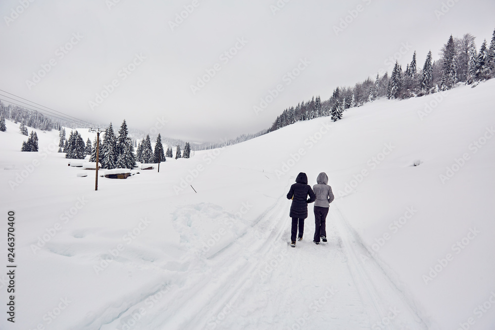 Tourists walking on a snowy trail