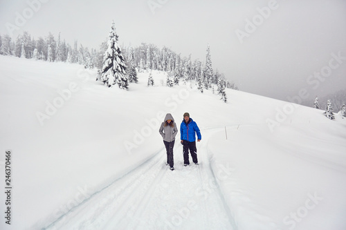 Friends hiking on a snowy trail