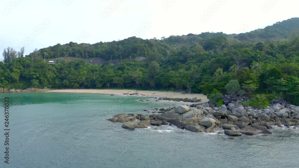 Aerial drone shot of beautiful rock beach with clear turquoise sea water in Phuket, Thailand. Exploration, wanderlust,power of nature and vacation destination concept. Aerial drone shot of beautiful rock beach with clear turquoise sea water in Phuket, Thailand. Exploration, wanderlust,power of nature and vacation destination concept.