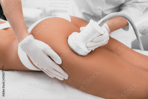 woman having cavitation, procedure removing cellulite on her buttocks , lifting buttocks