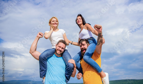 Time flies when we are having fun. Playful couples in love smiling on cloudy sky. Loving couples enjoy fun together. Happy men piggybacking girlfriends. Loving couples having fun activities outdoor