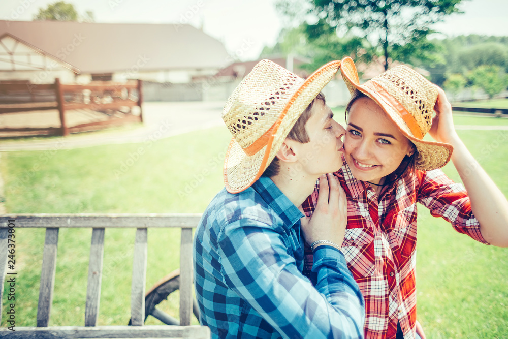 Happy young couple in love outdoors on picnic having a good leisure vacation together in cowboy style