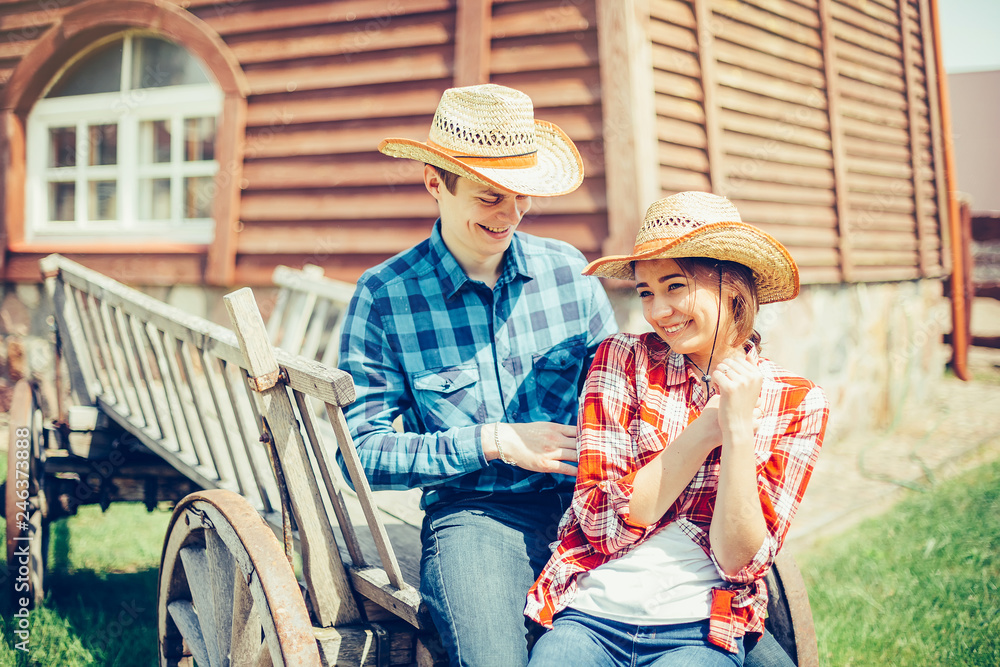 Happy young couple in love outdoors on picnic having a good leisure vacation together in cowboy style