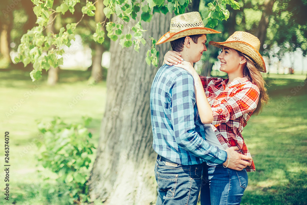Happy young couple in love outdoors on picnic having a good leisure vacation together in cowboy style