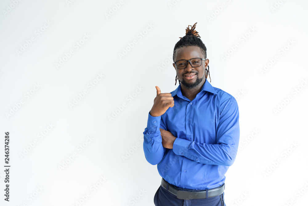 Fototapeta premium Happy black man showing thumb up and looking at camera. Young guy recommending something. Advertisement concept. Isolated front view on white background.