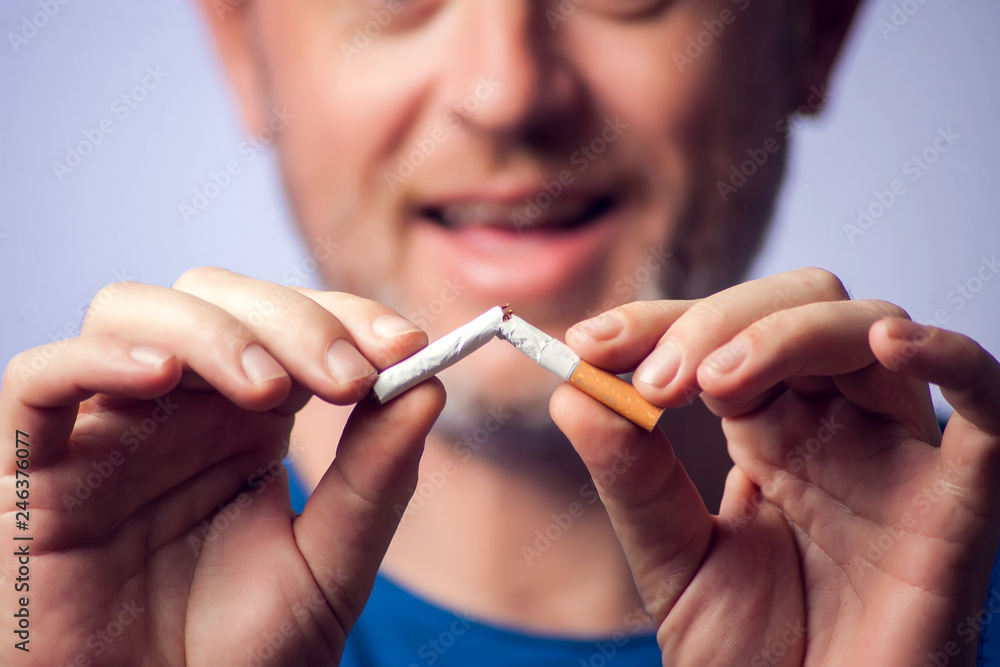 Stop smoking cigarettes concept. Broken cigarette in hands. Quit bad habit, health care concept. No smoking. Stop smoking cigarettes concept. Broken cigarette in hands. Quit bad habit, health care concept. No smoking.