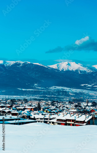 Mountain snow peak, Alpine village houses. Europe, old town winter ice hill top panoramic view.