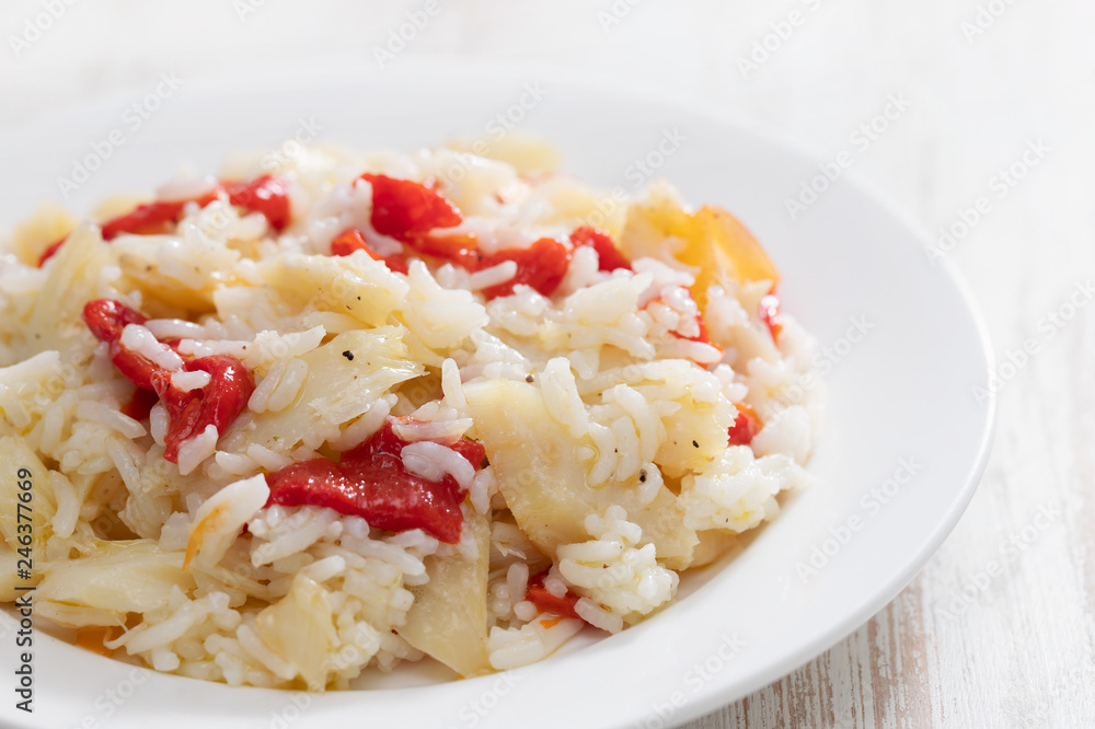 rice with cod fish and red pepper on white dish rice with cod fish and red pepper on white dish