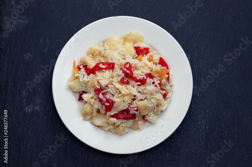 rice with cod fish and red pepper on white dish
