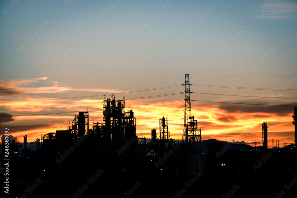 silhouette factory with dramatic sky background,petrochemical plant area with beautify sky at sunset.