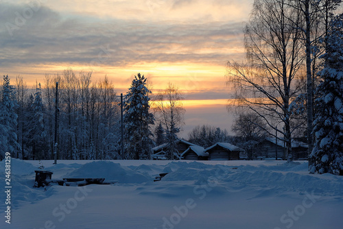 Frosty sunset in the village of Malye Karely, Arkhangelsk region, Russia