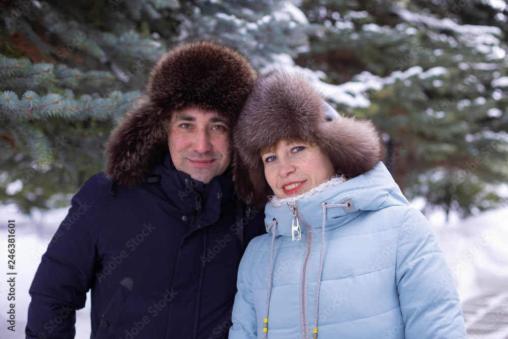 a man and a woman with a stroller on winter street a man and a woman with a stroller on winter street