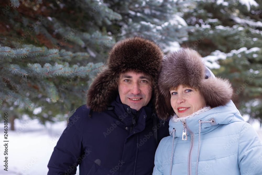 a man and a woman with a stroller on winter street a man and a woman with a stroller on winter street