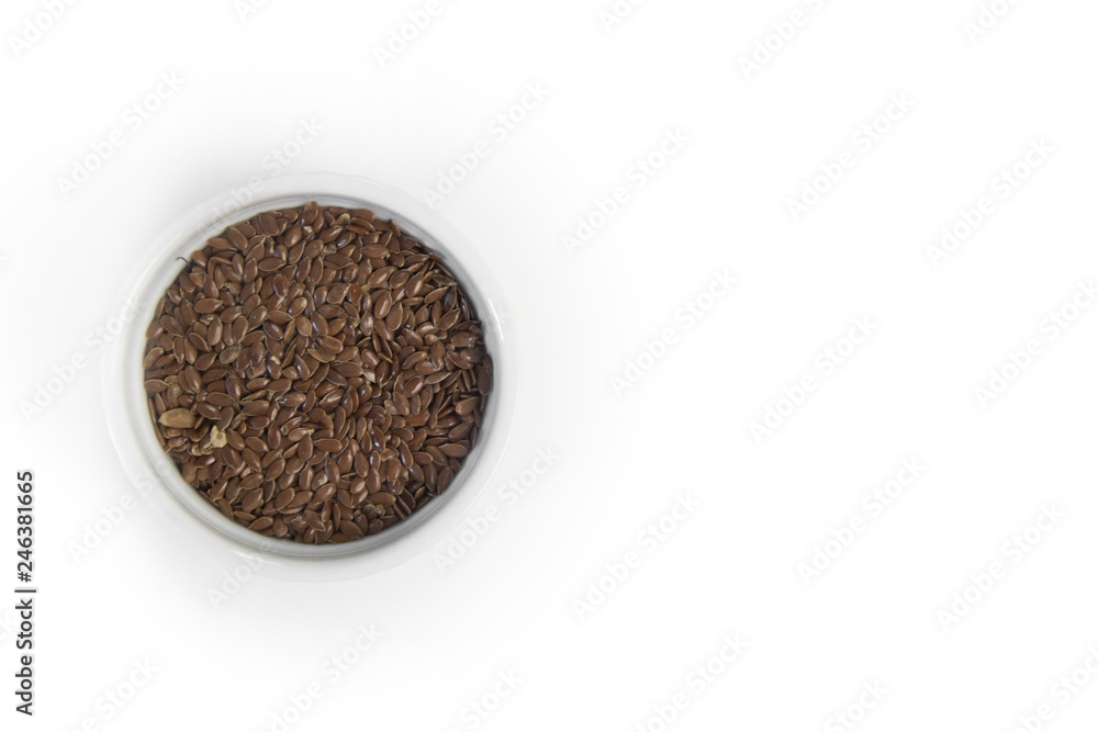 Flax seeds in white bowl on grey background, top view Flax seeds in white bowl on grey background, top view