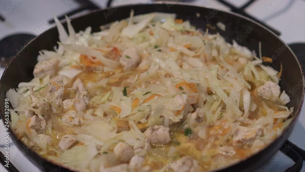 Braised cabbage with meat and carrots in a pan Braised cabbage with meat and carrots in a pan