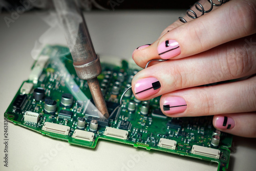 closeup of female hand holding circuit board