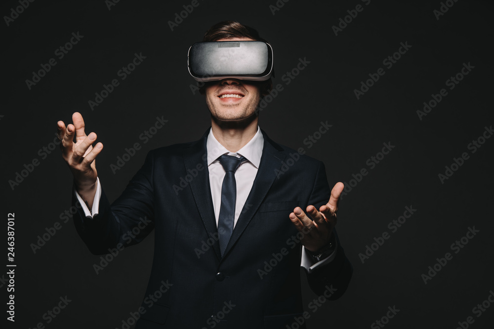 cheerful businessman in virtual reality headset isolated on black cheerful businessman in virtual reality headset isolated on black