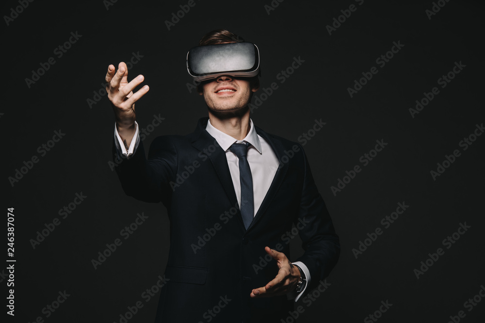 happy businessman in virtual reality headset isolated on black happy businessman in virtual reality headset isolated on black