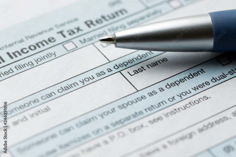 United States federal income tax return IRS 1040 document with blue pen United States federal income tax return IRS 1040 document with blue pen