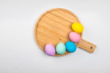 Colored eggs lie on a light wooden background, Concept illustration for Easter