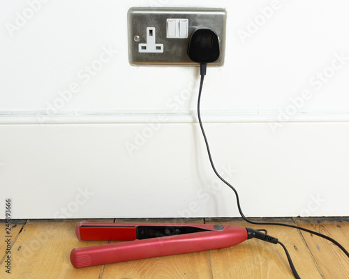 Hair straightener left plugged in and switched on. Safety concept