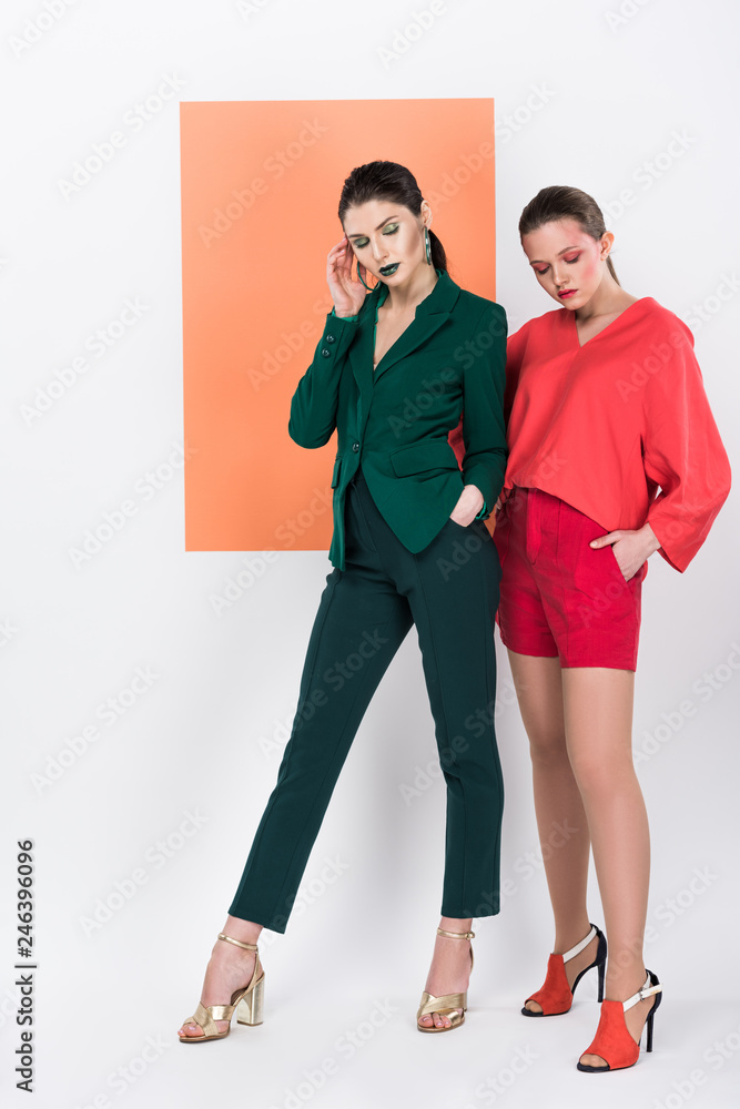 Fototapeta premium beautiful fashionable young women with eyes closed posing with living coral on background