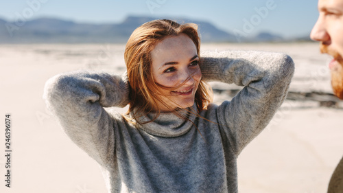 Woman on the beach looking at her boyfriend