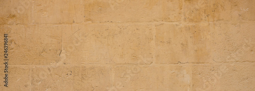 Traditional limestone wall facade background in Malta, banner