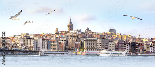 Panorama of Istanbul with Galata Tower at skyline and seagulls over the sea, wide landscape of Golden Horn, travel background for billboard photo