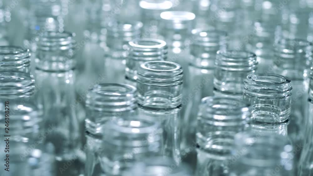 Empty bottles moving on a line, close up. Empty bottles moving on a line, close up.